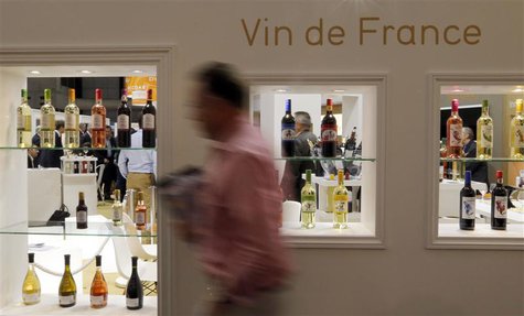 A visitor walks past wine bottles displayed at Vinexpo, the world's biggest wine fair, in Bordeaux, southwestern France, June 18, 2013. REUT A visitor walks past wine bottles displayed at Vinexpo, the world's biggest wine fair, in Bordeaux, southwestern France, June 18, 2013. REUT