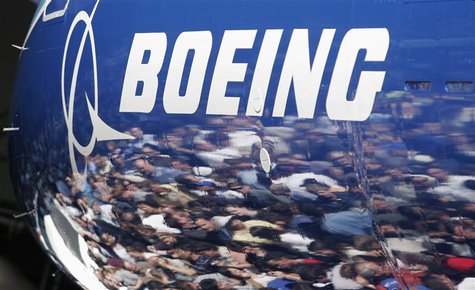Invited guests for the world premiere of the Boeing 787 Dreamliner are reflected in the fuselage of the aircraft at the 787 assembly plant i Invited guests for the world premiere of the Boeing 787 Dreamliner are reflected in the fuselage of the aircraft at the 787 assembly plant i