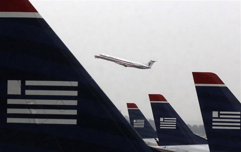 An American Eagle Embraer ERJ-140LR jet takes off as U.S. Airways jets are lined up at Reagan National Airport in Washington July 12, 2013. An American Eagle Embraer ERJ-140LR jet takes off as U.S. Airways jets are lined up at Reagan National Airport in Washington July 12, 2013.