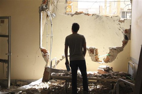 A man inspects damage at a hospital in Deir al-Zor July 28, 2013. REUTERS/Karam Jamal A man inspects damage at a hospital in Deir al-Zor July 28, 2013. REUTERS/Karam Jamal