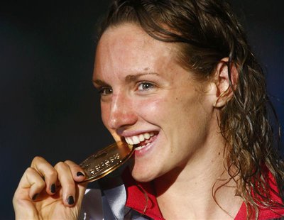 Hungary's Katinka Hosszu bites her gold medal at the women's 200m individual medley victory ceremony during the World Swimming Championships Hungary's Katinka Hosszu bites her gold medal at the women's 200m individual medley victory ceremony during the World Swimming Championships