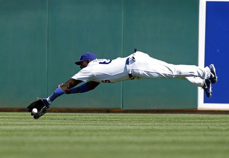 Los Angeles Dodgers center fielder Yasiel Puig attempts to make a diving catch of a fly ball off the bat of Cincinnati Reds' Brandon Phillip Los Angeles Dodgers center fielder Yasiel Puig attempts to make a diving catch of a fly ball off the bat of Cincinnati Reds' Brandon Phillip