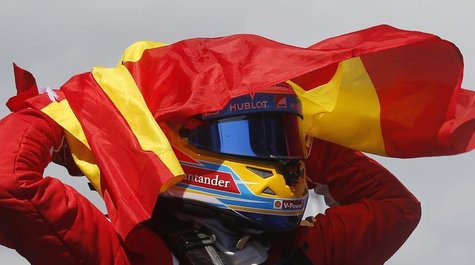 Ferrari Formula One driver Fernando Alonso of Spain holds up his national flag as he celebrates winning the Spanish F1 Grand Prix at the Cir Ferrari Formula One driver Fernando Alonso of Spain holds up his national flag as he celebrates winning the Spanish F1 Grand Prix at the Cir