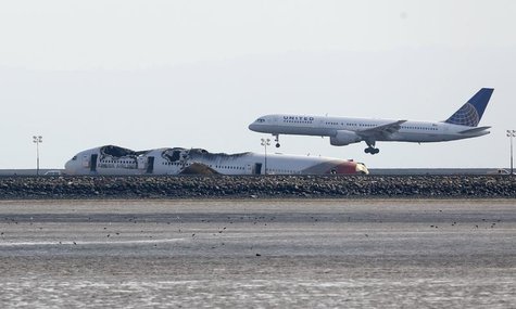 An aircraft lands behind the wreckage of the Asiana Airlines plane at San Francisco International Airport in San Francisco, California, July An aircraft lands behind the wreckage of the Asiana Airlines plane at San Francisco International Airport in San Francisco, California, July