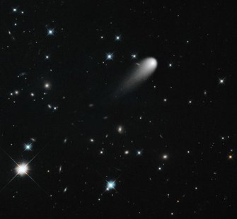 The sun-approaching Comet ISON floats against a seemingly infinite backdrop of numerous galaxies and a handful of foreground stars in this A The sun-approaching Comet ISON floats against a seemingly infinite backdrop of numerous galaxies and a handful of foreground stars in this A