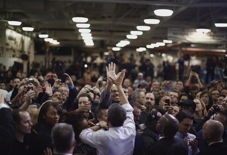 U.S. President Barack Obama high-fives an employee of the Daimler Detroit Diesel plant following remarks and a tour in Redford, Michigan, De U.S. President Barack Obama high-fives an employee of the Daimler Detroit Diesel plant following remarks and a tour in Redford, Michigan, De