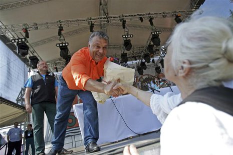 Hungary's Prime Minister Viktor Orban shakes hands with a supporter after addressing at the Tusvanyos summer University in Baile Tusnad, 230 Hungary's Prime Minister Viktor Orban shakes hands with a supporter after addressing at the Tusvanyos summer University in Baile Tusnad, 230