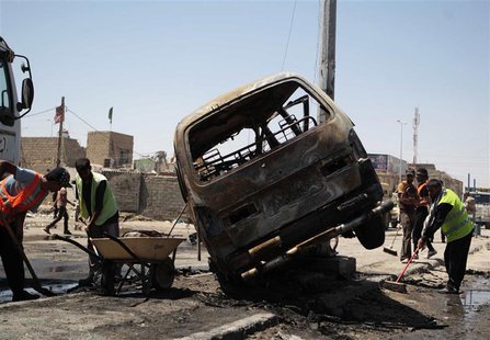 Street cleaners remove debris on the road at the site of a car bomb attack in Basra, 420 km (260 miles) southeast of Baghdad, July 29, 2013. Street cleaners remove debris on the road at the site of a car bomb attack in Basra, 420 km (260 miles) southeast of Baghdad, July 29, 2013.