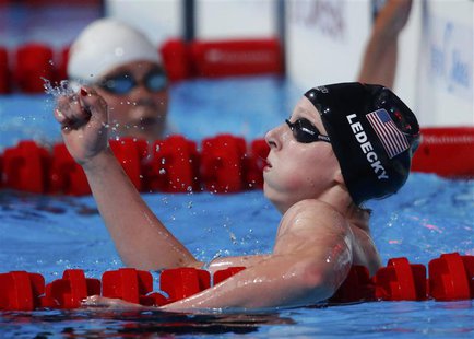 Katie Ledecky of the U.S. celebrates after setting a new world record to win the women's 1500m freestyle final during the World Swimming Cha Katie Ledecky of the U.S. celebrates after setting a new world record to win the women's 1500m freestyle final during the World Swimming Cha