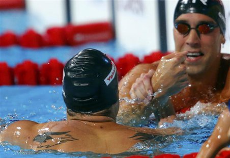 Matt Grevers of the U.S. (R) is congratulated by second place and compatriot David Plummer after winning the men's 100m backstroke final dur Matt Grevers of the U.S. (R) is congratulated by second place and compatriot David Plummer after winning the men's 100m backstroke final dur