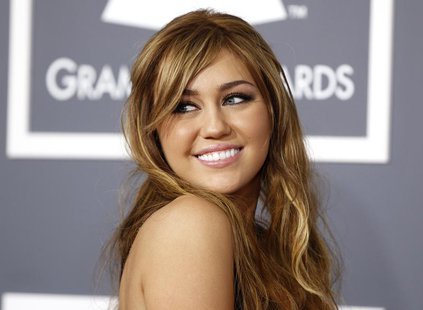 Miley Cyrus poses on arrival at the 53rd annual Grammy Awards in Los Angeles, California February 13, 2011. REUTERS/Danny Moloshok Miley Cyrus poses on arrival at the 53rd annual Grammy Awards in Los Angeles, California February 13, 2011. REUTERS/Danny Moloshok