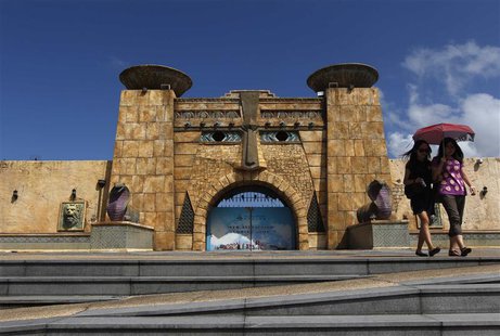 Women walk in front of a closed entrance to an attraction at Fisherman's Wharf in Macau July 28, 2013. REUTERS/Tyrone Siu Women walk in front of a closed entrance to an attraction at Fisherman's Wharf in Macau July 28, 2013. REUTERS/Tyrone Siu