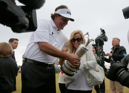 Phil Mickelson of the U.S. (L) holds the Claret Jug as he celebrates with his wife Amy after winning the British Open golf championship at M Phil Mickelson of the U.S. (L) holds the Claret Jug as he celebrates with his wife Amy after winning the British Open golf championship at M