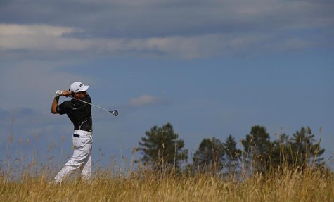 Louis Oosthuizen of South Africa watches his tee shot on the sixth hole during the first round of the British Open golf Championship at Muir Louis Oosthuizen of South Africa watches his tee shot on the sixth hole during the first round of the British Open golf Championship at Muir
