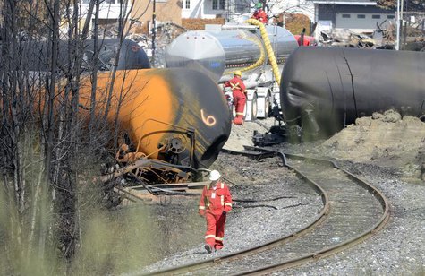 A worker walks near the railway track on the site of the train wreck in Lac Megantic, July 16, 2013. REUTERS/Ryan Remiorz/Pool A worker walks near the railway track on the site of the train wreck in Lac Megantic, July 16, 2013. REUTERS/Ryan Remiorz/Pool