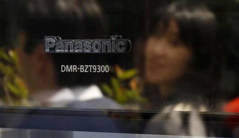 Passers-by are reflected on a product of Panasonic Corp outside an electronics store in Tokyo May 9, 2013. REUTERS/Toru Hanai Passers-by are reflected on a product of Panasonic Corp outside an electronics store in Tokyo May 9, 2013. REUTERS/Toru Hanai