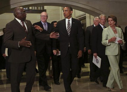 U.S. President Barack Obama (C) confers with House Minority Leader Rep. Nancy Pelosi (D-CA) (R) and Rep. James Clyburn (D-SC) (L) after a me U.S. President Barack Obama (C) confers with House Minority Leader Rep. Nancy Pelosi (D-CA) (R) and Rep. James Clyburn (D-SC) (L) after a me