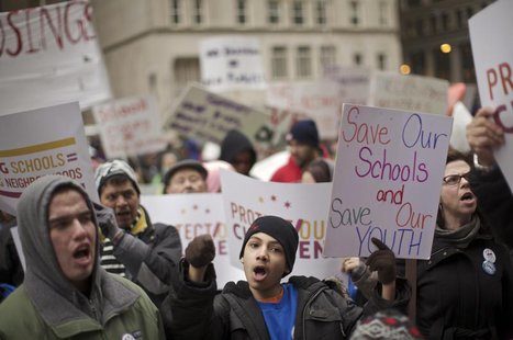 Demonstrators hold placards during a Chicago Teachers Union protest in Chicago March 27, 2013. REUTERS/John Gress Demonstrators hold placards during a Chicago Teachers Union protest in Chicago March 27, 2013. REUTERS/John Gress