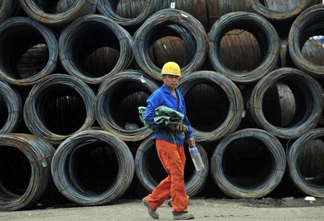 A labourer walks past piles of steel coils at a steel wholesale market in Shenyang, Liaoning province July 15, 2013. REUTERS/Stringer A labourer walks past piles of steel coils at a steel wholesale market in Shenyang, Liaoning province July 15, 2013. REUTERS/Stringer