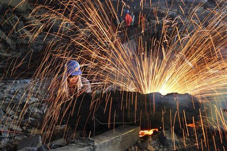 A labourer cuts scrap steel at a factory of Dongbei Special Steel Group Co., Ltd., in Dalian, Liaoning province July 24, 2013. REUTERS/China A labourer cuts scrap steel at a factory of Dongbei Special Steel Group Co., Ltd., in Dalian, Liaoning province July 24, 2013. REUTERS/China