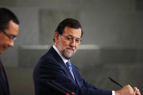 Spain's Prime Minister Mariano Rajoy looks on during a joint news conference with his Romanian counterpart Victor Ponta (L) after their meet Spain's Prime Minister Mariano Rajoy looks on during a joint news conference with his Romanian counterpart Victor Ponta (L) after their meet