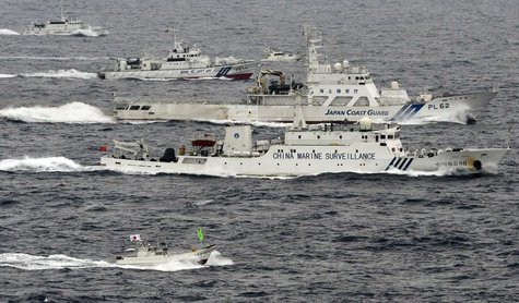 An aerial photo shows a Chinese marine surveillance ship Haijian No. 66 (C) cruising next to Japan Coast Guard patrol ships in the East Chin An aerial photo shows a Chinese marine surveillance ship Haijian No. 66 (C) cruising next to Japan Coast Guard patrol ships in the East Chin