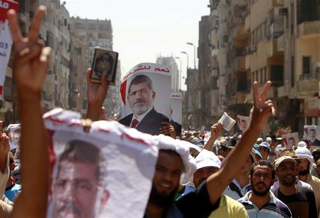 Supporters of deposed Egyptian President Mohamed Mursi shout slogans during a march from Al-Fath Mosque to the defence ministry, in Cairo Ju Supporters of deposed Egyptian President Mohamed Mursi shout slogans during a march from Al-Fath Mosque to the defence ministry, in Cairo Ju