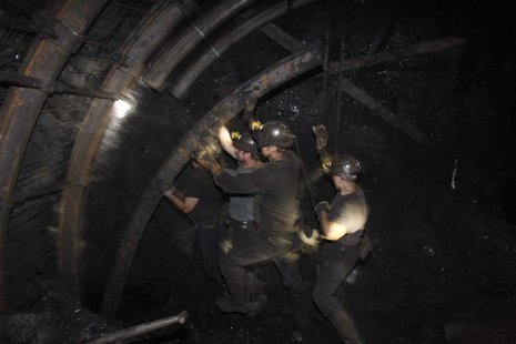 A group of miners secure a wall inside of an excavation corridor at Zofiowka coal mine of the JSW coal mine company, in Jastrzebie Zdroj, so A group of miners secure a wall inside of an excavation corridor at Zofiowka coal mine of the JSW coal mine company, in Jastrzebie Zdroj, so