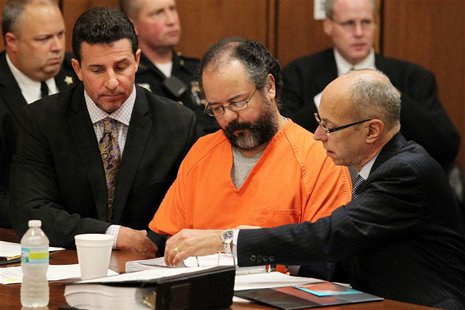 Ariel Castro (C), 53, sits as his attorneys Craig Weintraub (L) and Jaye Schlachet (R) review documents during Castro's sentencing on Kidnap Ariel Castro (C), 53, sits as his attorneys Craig Weintraub (L) and Jaye Schlachet (R) review documents during Castro's sentencing on Kidnap