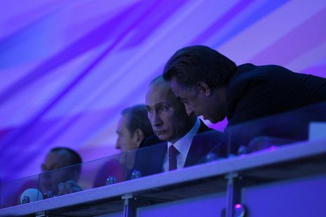 Russian President Vladimir Putin (L) listens to Sports Minister Vitaly Mutko as he watches the ceremony during the opening of the Summer Uni Russian President Vladimir Putin (L) listens to Sports Minister Vitaly Mutko as he watches the ceremony during the opening of the Summer Uni