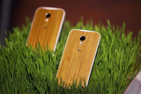 Phones with wooden backs on them rest in a display at a launch event for Motorola's new Moto X phone in New York, August 1, 2013. REUTERS/Lu Phones with wooden backs on them rest in a display at a launch event for Motorola's new Moto X phone in New York, August 1, 2013. REUTERS/Lu