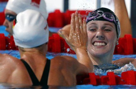 Missy Franklin of the U.S. (R) is congratulated by Germany's Britta Steffen after competing in the women's 100m freestyle semi-final during Missy Franklin of the U.S. (R) is congratulated by Germany's Britta Steffen after competing in the women's 100m freestyle semi-final during
