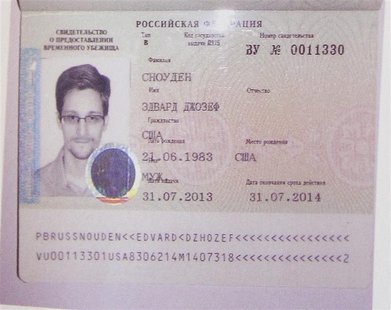 Fugitive former U.S. spy agency contractor Edward Snowden's new refugee documents granted by Russia is seen during a news conference in Mosc Fugitive former U.S. spy agency contractor Edward Snowden's new refugee documents granted by Russia is seen during a news conference in Mosc