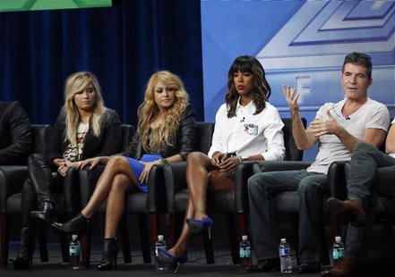Judge Simon Cowell speaks next to fellow judges (from L-R) Demi Lovato, Paulina Rubio and Kelly Rowland at a panel for the television series Judge Simon Cowell speaks next to fellow judges (from L-R) Demi Lovato, Paulina Rubio and Kelly Rowland at a panel for the television series