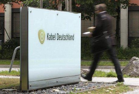 A man passes the company logo of German cable television group Kabel Deutschland in Unterfoehring north of Munich June 24, 2013. REUTERS/Mic A man passes the company logo of German cable television group Kabel Deutschland in Unterfoehring north of Munich June 24, 2013. REUTERS/Mic