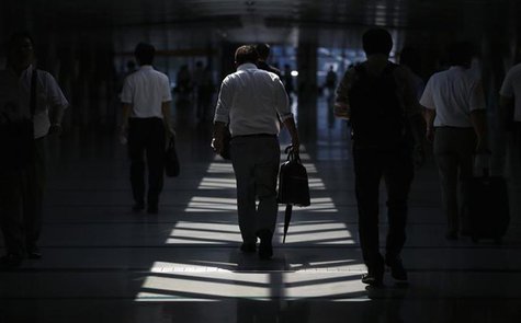 Businessmen walk in a convention centre in Tokyo July 18, 2013.REUTERS/Toru Hanai Businessmen walk in a convention centre in Tokyo July 18, 2013.REUTERS/Toru Hanai