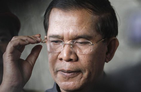 Cambodia's Prime Minister Hun Sen reacts as he speaks to the media during an inspection of a bridge construction site in Phnom Penh July 31, Cambodia's Prime Minister Hun Sen reacts as he speaks to the media during an inspection of a bridge construction site in Phnom Penh July 31,