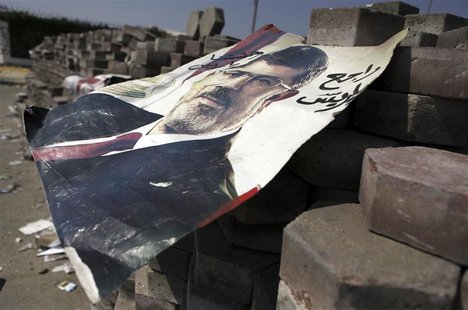 A poster of deposed Egyptian President Mohamed Mursi is seen on bricks placed throughout the camp, at the entrance to their campsite near th A poster of deposed Egyptian President Mohamed Mursi is seen on bricks placed throughout the camp, at the entrance to their campsite near th