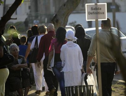 People walk in line to apply for visas at the U.S. diplomatic mission in Cuba, The United States Interests Section, (USINT), in Havana Febru People walk in line to apply for visas at the U.S. diplomatic mission in Cuba, The United States Interests Section, (USINT), in Havana Febru