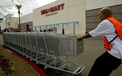 Employees move shopping carts as the first Wal Mart Supercenter to operate in the State of California, opened in La Quinta, California, Marc Employees move shopping carts as the first Wal Mart Supercenter to operate in the State of California, opened in La Quinta, California, Marc