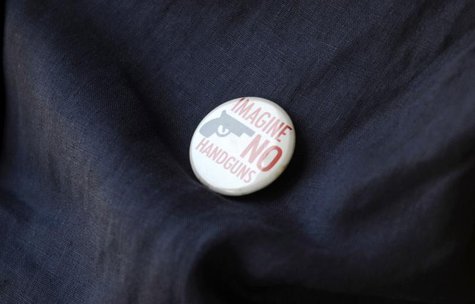 An opponent of Florida's 'Stand Your Ground' law wears a button against handguns outside a meeting o the law in Longwood, Florida, June 12, An opponent of Florida's 'Stand Your Ground' law wears a button against handguns outside a meeting o the law in Longwood, Florida, June 12,