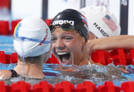 Yuliya Efimova of Russia reacts between Mariia Liver of Ukraine (L) and Jessica Hardy of the U.S. (R) after the women's 50m breaststroke hea Yuliya Efimova of Russia reacts between Mariia Liver of Ukraine (L) and Jessica Hardy of the U.S. (R) after the women's 50m breaststroke hea