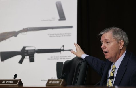 U.S. Senator Lindsey Graham (R-SC) points at a chart showing an (bottom to top) AR-15 semi-automatic rifle, a 12 gauge shotgun and a 15-roun U.S. Senator Lindsey Graham (R-SC) points at a chart showing an (bottom to top) AR-15 semi-automatic rifle, a 12 gauge shotgun and a 15-roun