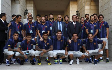 Barcelona President Sandro Rosell (centre R), Palestinian Football Association President Jibril Rajoub (C) and Barcelona soccer players pose Barcelona President Sandro Rosell (centre R), Palestinian Football Association President Jibril Rajoub (C) and Barcelona soccer players pose