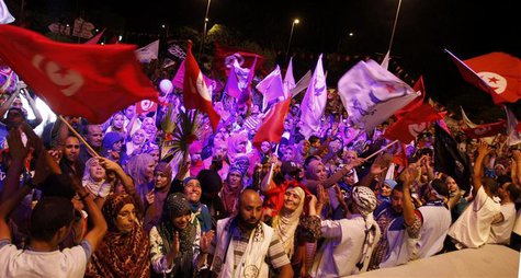 Supporters of the Islamist Ennahda movement wave flags as they chant slogans during a demonstration in support of the Ennahda government and Supporters of the Islamist Ennahda movement wave flags as they chant slogans during a demonstration in support of the Ennahda government and