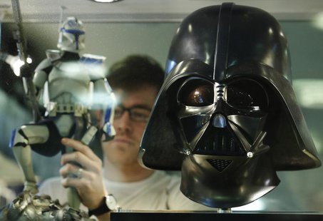 Employee Simon Domoney adjusts a Captain Rex figure alongside a scale replica of Star Wars character Darth Vader's helmet at the Forbidden P Employee Simon Domoney adjusts a Captain Rex figure alongside a scale replica of Star Wars character Darth Vader's helmet at the Forbidden P