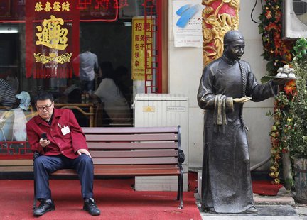 A man sits on a bench in front of a restaurant at a shopping district in Beijing May 6, 2013. REUTERS/Kim Kyung-Hoon A man sits on a bench in front of a restaurant at a shopping district in Beijing May 6, 2013. REUTERS/Kim Kyung-Hoon