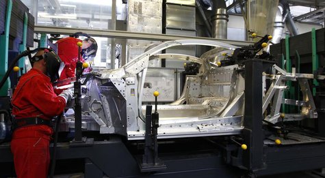 Workers assemble a new Audi R8 car body in the automotive welding and assembly lines hall of the German car manufacturer's plant in Neckarsu Workers assemble a new Audi R8 car body in the automotive welding and assembly lines hall of the German car manufacturer's plant in Neckarsu