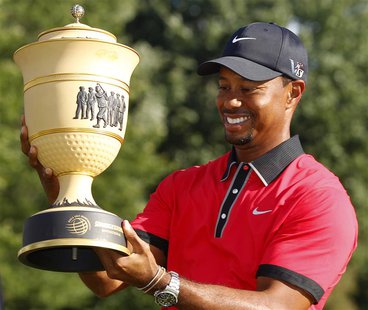 Tiger Woods of the U.S. holds the trophy after winning the WGC-Bridgestone Invitational golf tournament in Akron, Ohio, August 4, 2013. REUT Tiger Woods of the U.S. holds the trophy after winning the WGC-Bridgestone Invitational golf tournament in Akron, Ohio, August 4, 2013. REUT