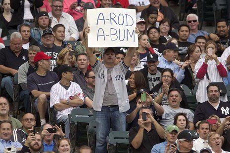 A fans hold up a sign as New York Yankee's Alex Rodriguez prepares to bat while playing the Chicago White Sox in the second inning of their A fans hold up a sign as New York Yankee's Alex Rodriguez prepares to bat while playing the Chicago White Sox in the second inning of their